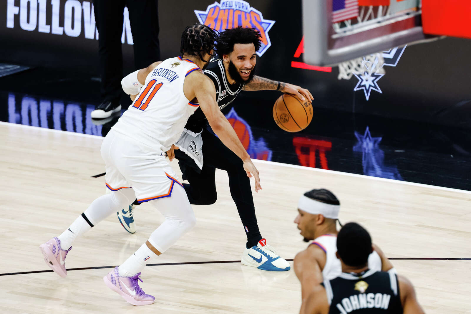 Spurs forward Julian Champagnie drives the ball toward the net while guarded by Knicks guard Jalen Brunson during Game 1 of the NBA Finals. (Sam Owens/San Antonio Express-News)