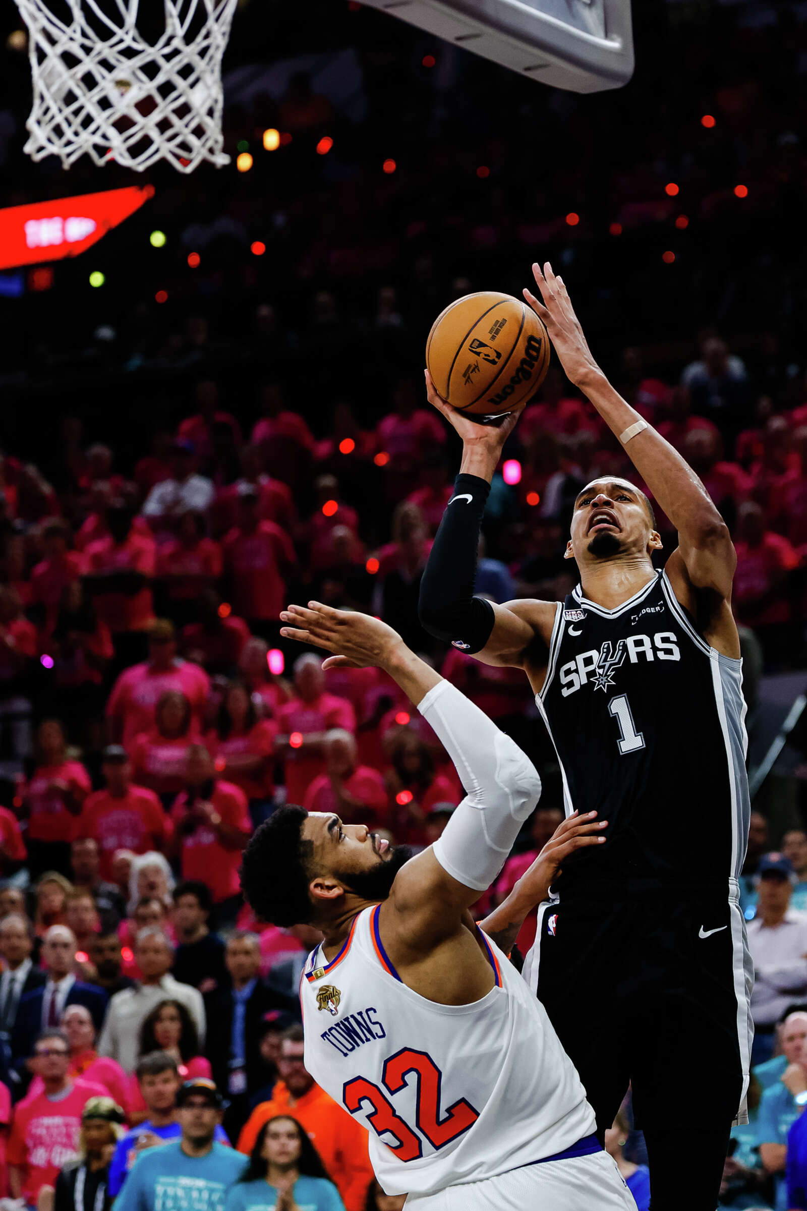Spurs center Victor Wembanyama goes up for a shot while defended by New York Knicks center Karl-Anthony Towns during Game 1 of the NBA Finals. (Sam Owens/San Antonio Express-News)