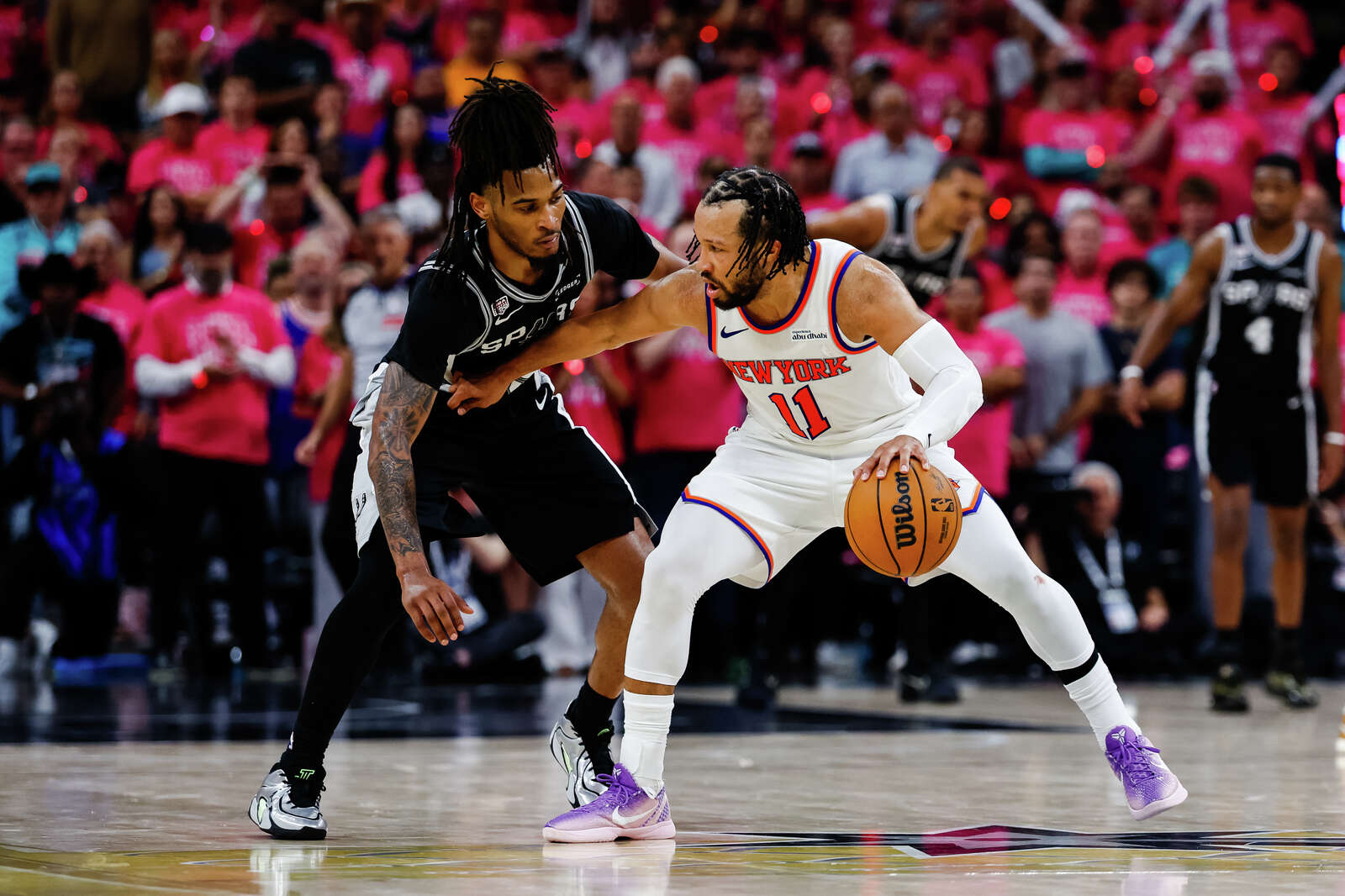 Knicks guard Jalen Brunson dribbles the ball while guarded by San Antonio Spurs guard Stephon Castle during Game 1 of the NBA Finals. (Sam Owens/San Antonio Express-News)
