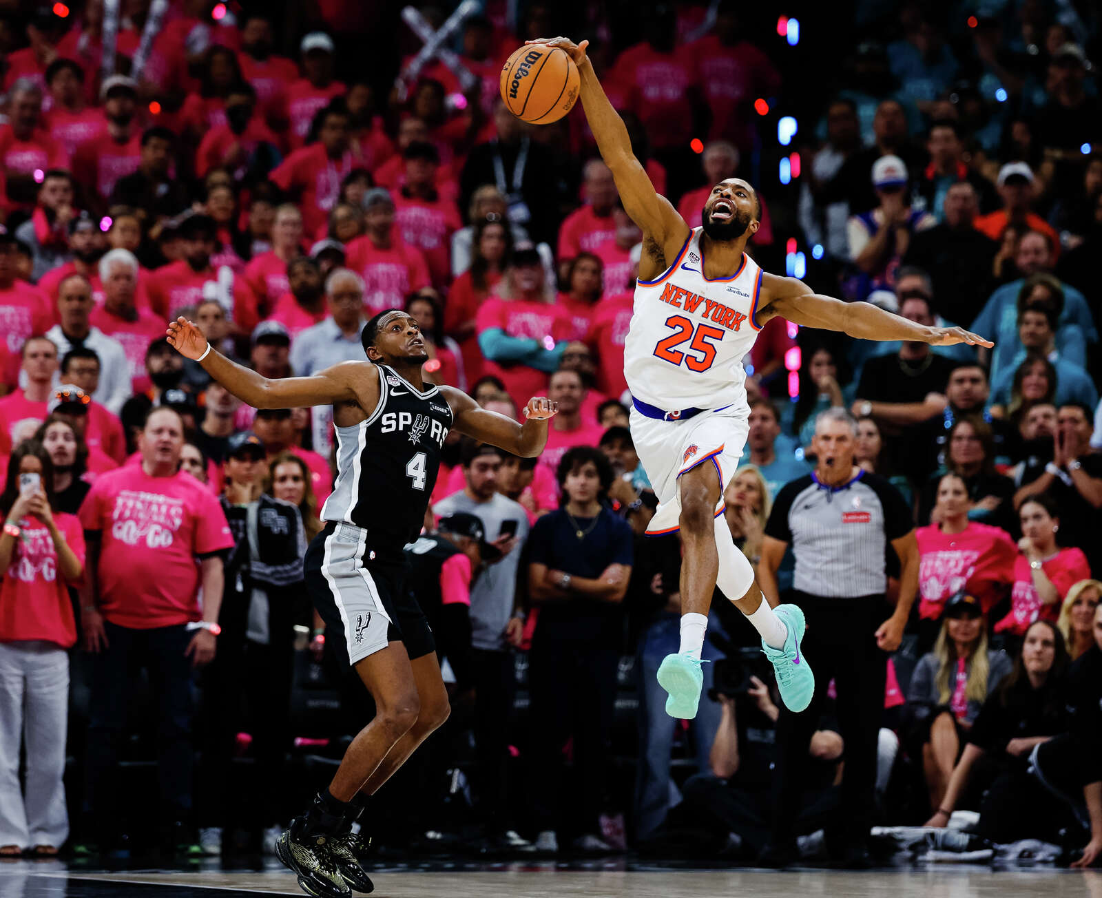 New York Knicks guard Mikal Bridges gets fouled by San Antonio Spurs guard De'Aaron Fox during Game 1 of the NBA Finals. (Sam Owens/San Antonio Express-News)