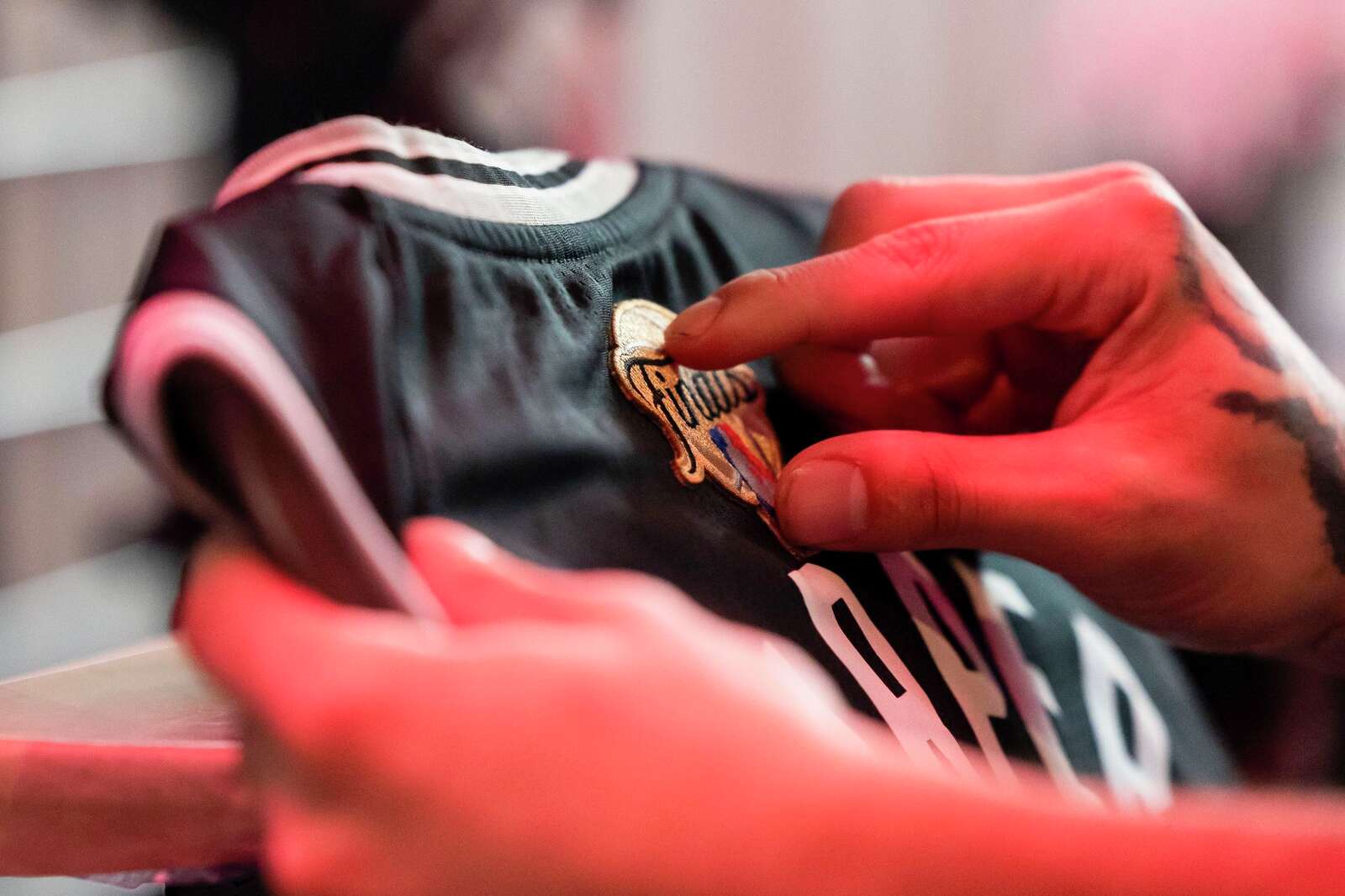 Jay Esparza prepares to place Finals patch on a jersey prior to the start of Game 2 of the NBA Finals.