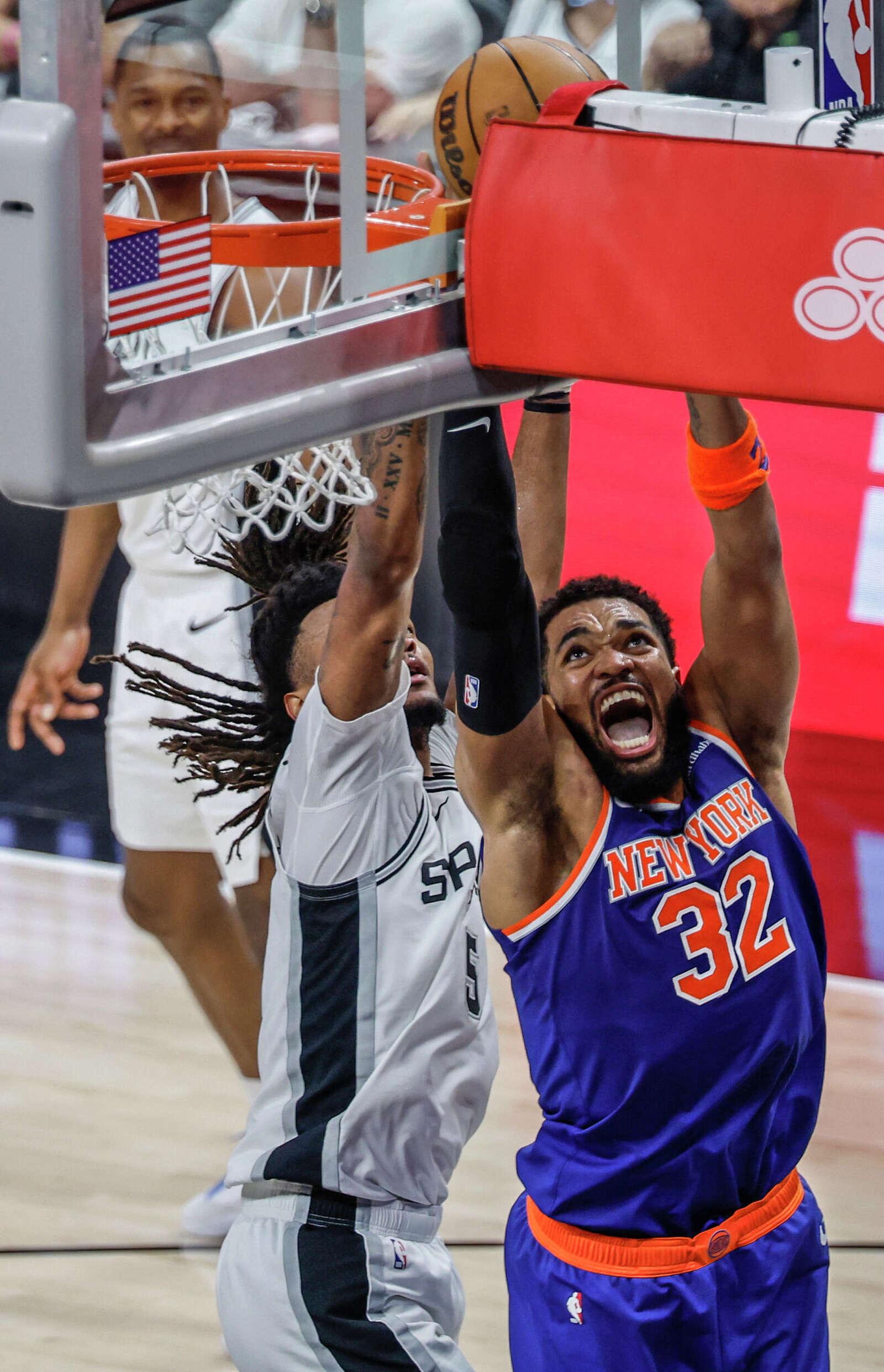 New York Knicks center Karl-Anthony Towns (32) tries for a layup past San Antonio Spurs guard Stephon Castle (5) during the second quarter.