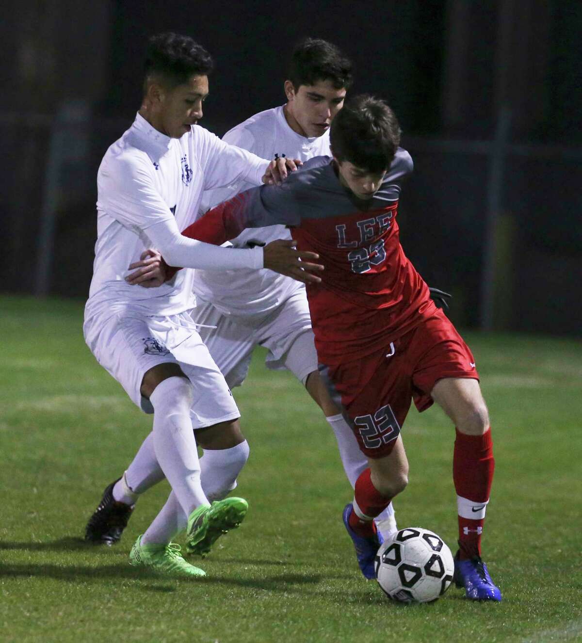 Legacy of Educational Excellence (LEE) player Henry Bowland (23) battles to keep control of the ball against Central Catholic's Angel Bacho (11) and Carlos Melo (04) in boys soccer at Blossom Soccer Complex on Tuesday, Jan. 15, 2019. Central Catholic was No. 1 in the nation last week and is two-time defending TAPPS-I state champion. LEE was a regional finalist a year ago, losing to Reagan 1-0 and falling one win shy of advancing to the UIL Class 6A state tournament. LEE defeated Central Catholic 2-1. (Kin Man Hui/San Antonio Express-News)