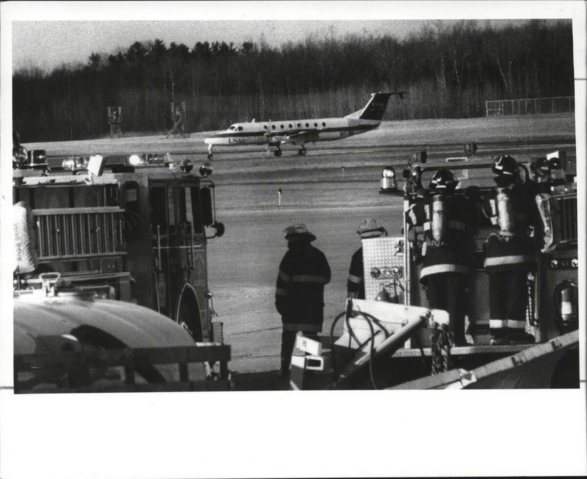 The Colonie Fire Department stands by as a US Air flight with a troubled landing gear signal lands safely at Albany Airport March 26, 1990.