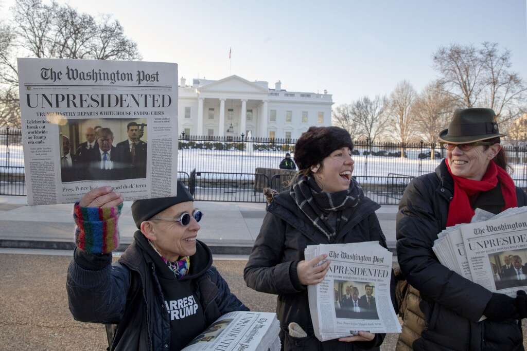 <p>Volunteers distribute a lookalike "special edition" of The Washington Post, date May 1, which predicts Trump leaving office after months of women-led protests on January 16, 2019 in Washington, DC.</p>