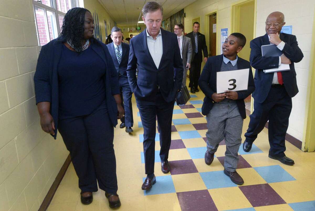 Governor Ned Lamont, second from left, tours Tracey Elementary School with principal Theresa Rangel, 5th grader Adrien Danso, and Dr. James Comer, Founder of the Yale Child Study Center, Wednesday January 16, 2019, prior to a roundtable discussion hosted by the Dalio Foundation at the school in Norwalk, Conn. The event highlighted the forthcoming release of a report from The Aspen Institute National Commission on Social, Emotional, and Academic Development titled, From a Nation at Risk to a Nation at Hope, which outlines steps officials should take to improve public education in the United States.