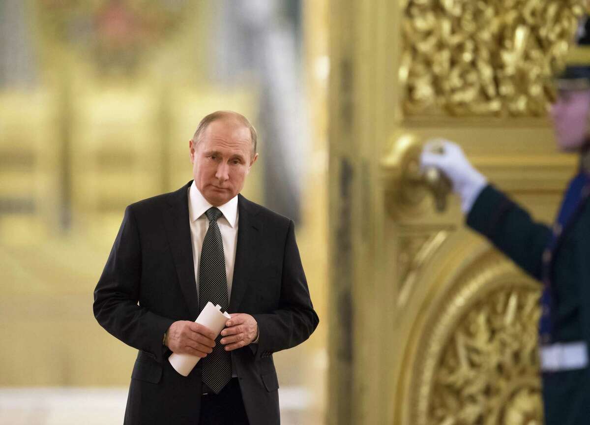 FILE In this file photo taken on Thursday, April 5, 2018, Russian President Vladimir Putin enters a hall to chair a meeting of the State Council in the Kremlin in Moscow, Russia. U.S. and European sanctions have restricted Russiaís access to international capital markets, limited imports of Western energy and military technologies and spooked international investors. (AP Photo/Alexander Zemlianichenko, Pool, File)