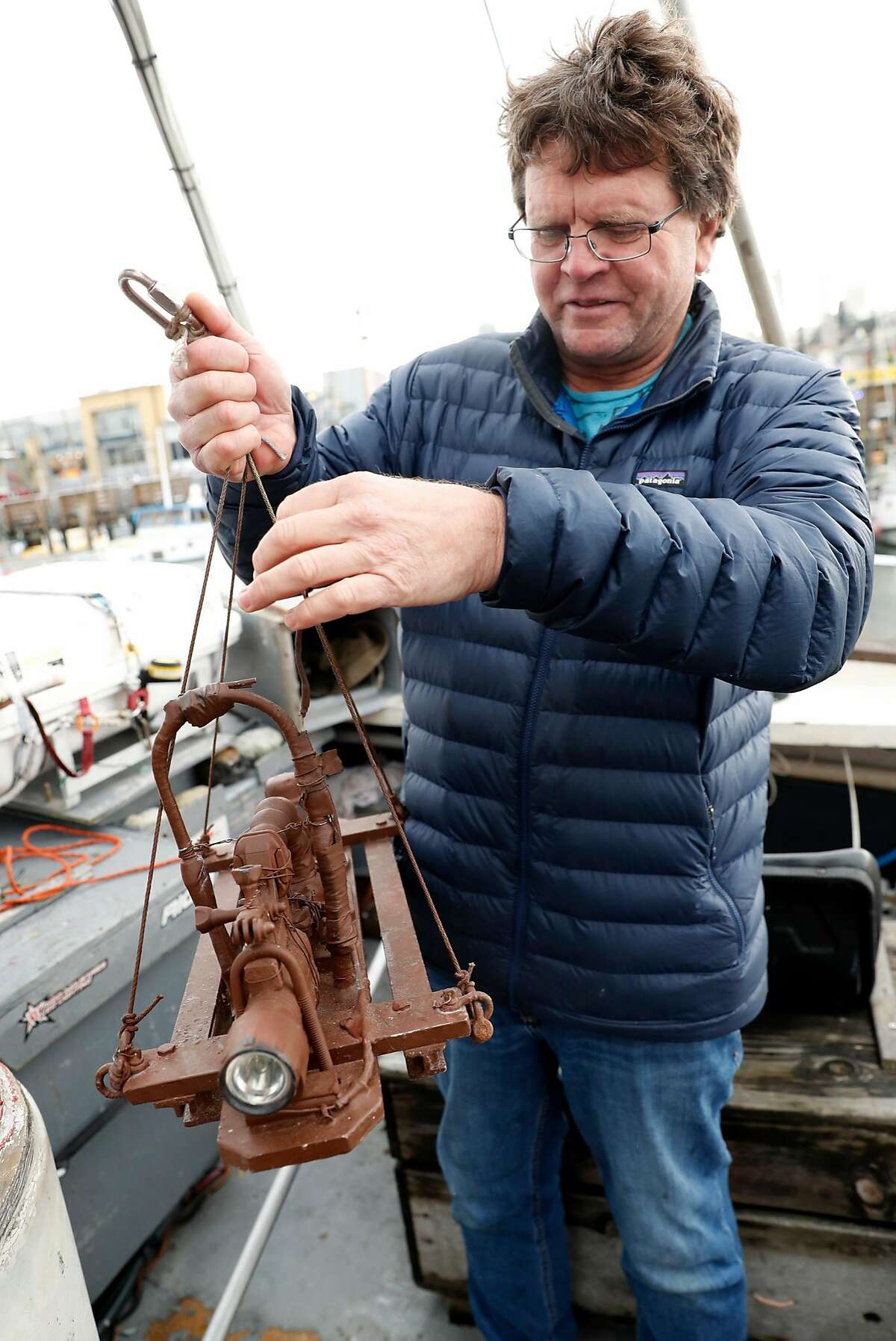 John Miller holds "The Sledge." his underwater rig that he uses a GoPro on to study herring. Photographed on Miller's boat, High Hopes, at Pier 45 in San Francisco, Calif. on Monday, January 14, 2019.