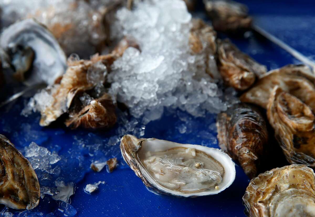 Raw oysters shipped in from Washington state are shucked by diners at Hog Island Oyster Farm in Marshall, Calif. on Wednesday, Jan. 16, 2019. Harvesting on Tomales Bay has been temporarily suspended following reports of a few customers becoming infected with norovirus after consuming the oysters.