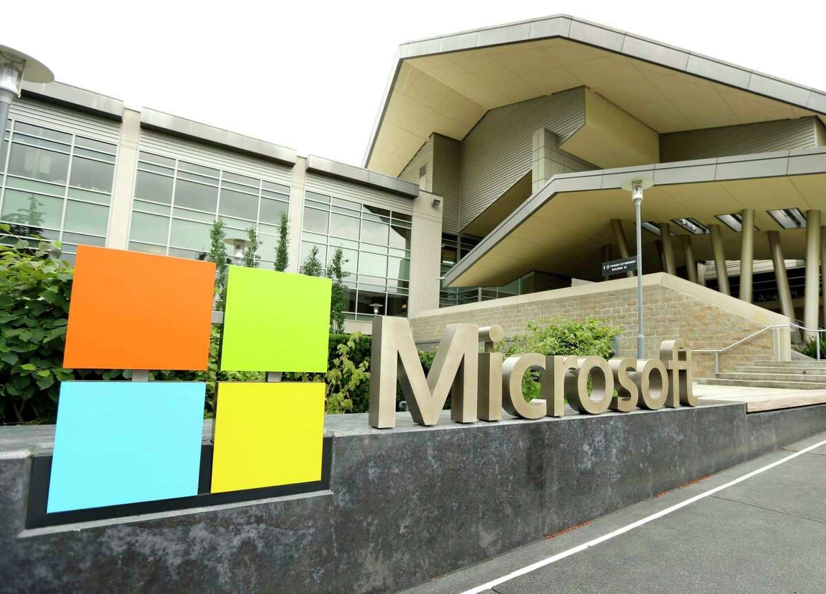 FILE - This July 3, 2014 file photo shows Microsoft Corp. signage outside the Microsoft Visitor Center in Redmond, Wash.