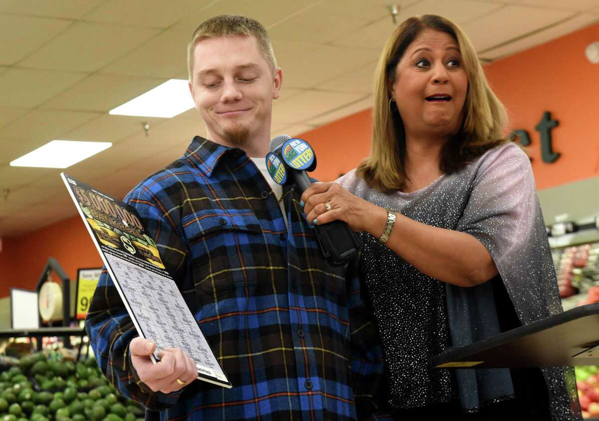Jeremy Stark, 29, of Selkirk, left, is announced as the winner of a $5 million scratch-off lottery ticket by Yolanda Vega of the New York State Gaming Commission, right, on Thursday, Jan. 17, 2019, at the Shop N Save supermarket in Ravena, N.Y. (Will Waldron/Times Union)