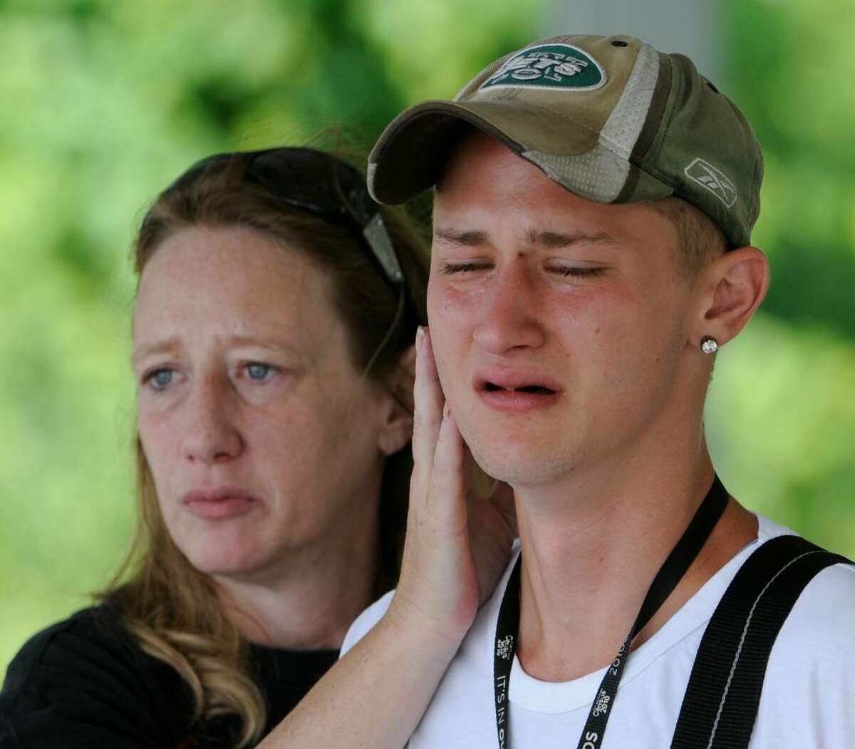 Cody Peck is comforted by his mother, Vess Peck, as the body of his companion who he tried to save was recovered Wednesday from the Hudson River across from the Hudson Shores Park in Watervliet. (Skip Dickstein / Times Union)
