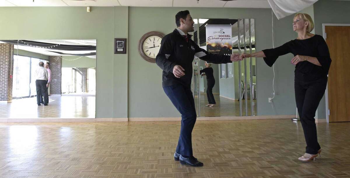 Arthur Murray dance studio Instructor Julio Cesar Sirianni, left, works with Deb Hendrickson, of Fairfield, in the Danbury studio. Arthur Murray offered discounted dance lessons to benefit Housatonic Habitat for Humanity on Friday, January 11, 2019, in Danbury, Conn.
