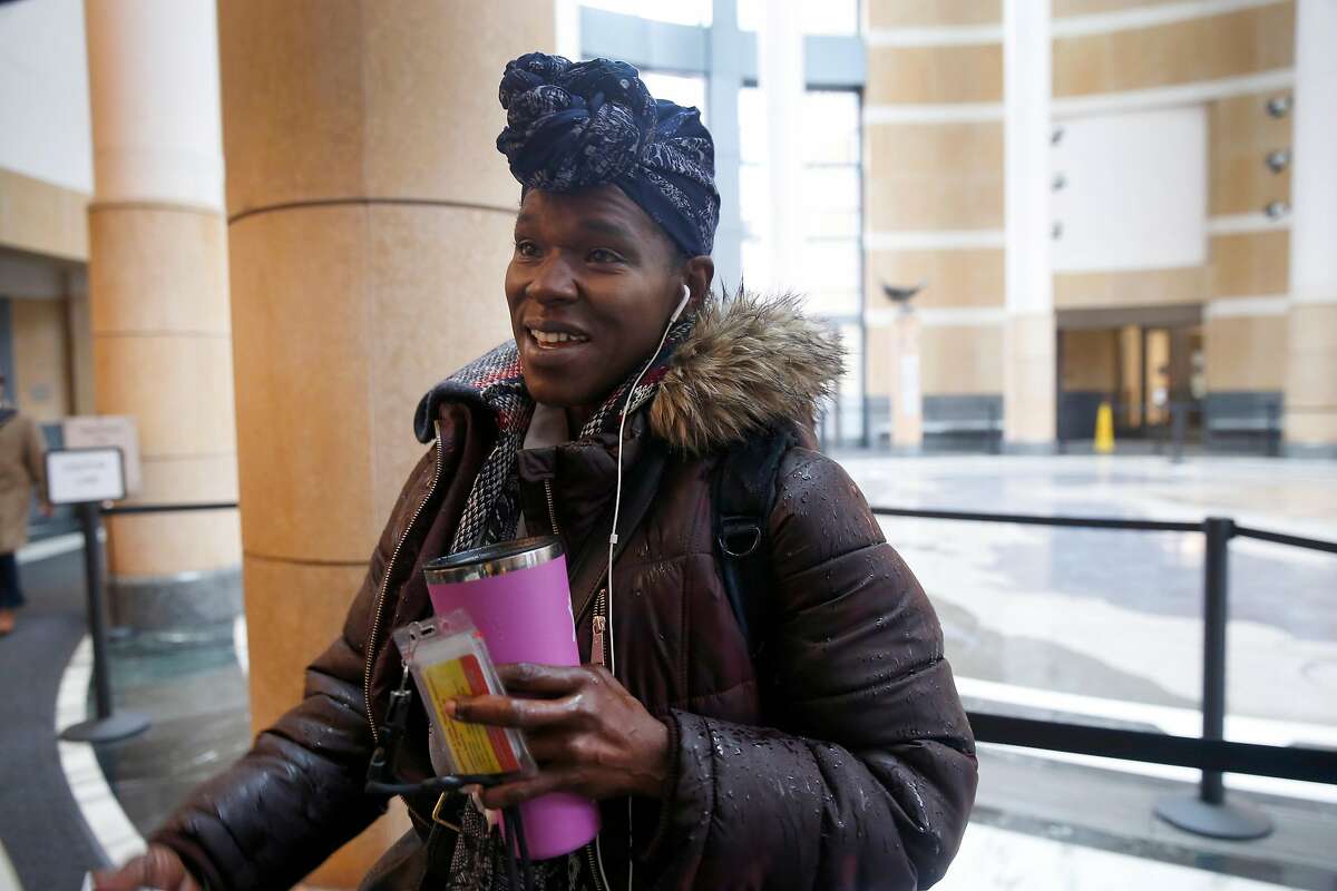 An Internal Revenue Service employee, who declined to give her name, reports for work at the Ronald Dellums Federal Building in Oakland, Calif. on Thursday, Jan. 17, 2019. Despite being unpaid during the partial government shutdown, the woman described herself as "a happy employee of the federal government."