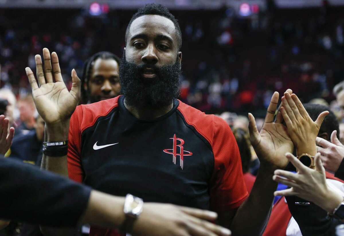 Houston Rockets guard James Harden high fives fans as he leaves the court after the Rockets 112-94 win over the Memphis Grizzlies during the second half of an NBA basketball game at Toyota Center on Monday, Jan. 14, 2019, in Houston.