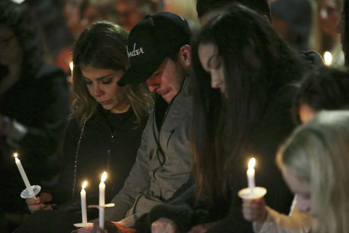 Friends and family gather during a vigil for Nichol Olsen and her two children at the Oblate Mission Lourdes Grotto on Jan. 16. The candlelight vigil honored Olsen, 37, and her two daughters, Alexa Denise Montez, 16, and London Sophia Bribiescas, 10, who were found shot to death at a home near Leon Springs last week.