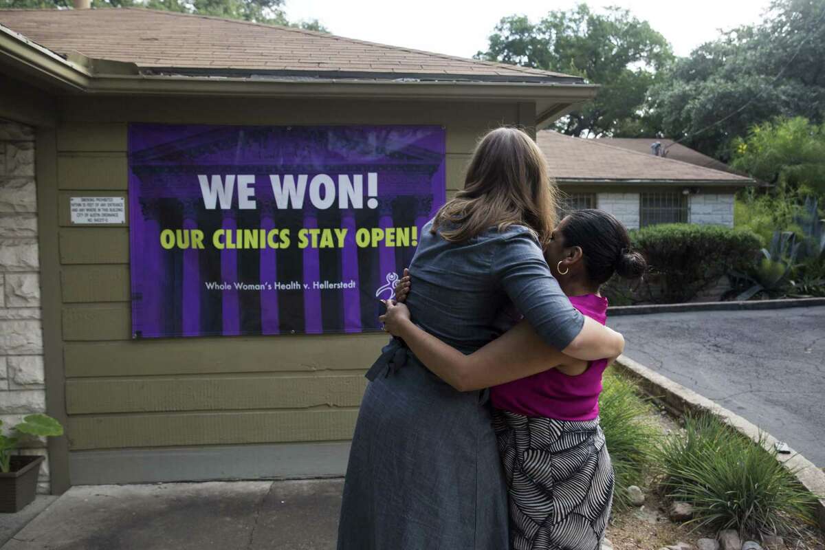 Stephanie Shea and Delma Limones hug on June 27, 2016, after revealing a sign indicating the U.S. Supreme Court ruled in favor of Whole Woman's Health in its lawsuit opposing Texas’ stricter abortion provider regulations.