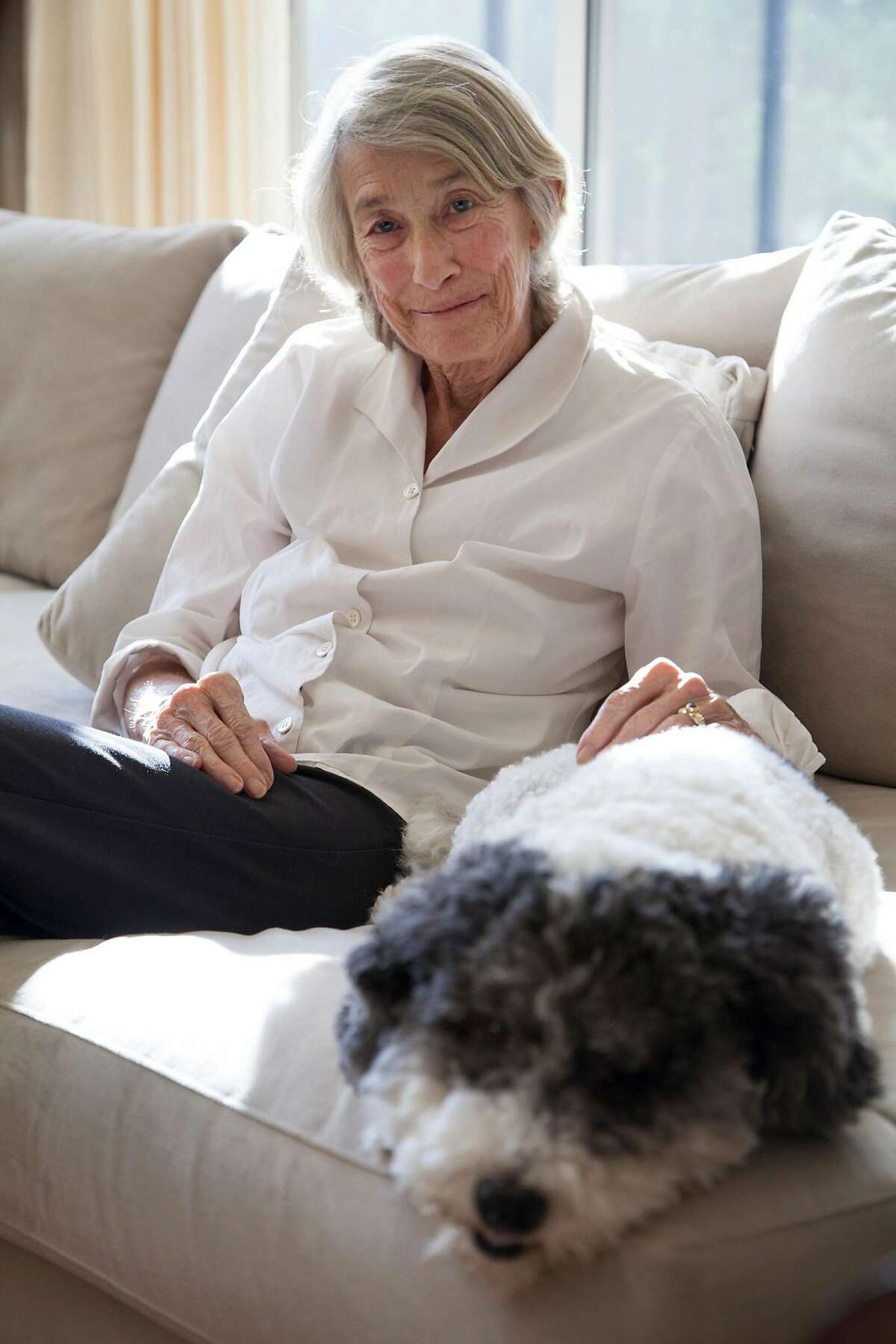 FILE -- Mary Oliver, a Pulitzer Prize-winning poet, with her dog, Ricky, at her home in Hobe Sound, Fla., Sept. 26, 2013. Oliver, whose work, with its plain language and minute attention to the natural world, drew a wide following while dividing critics, died on Jan. 17, 2019, at her home in Hobe Sound, Fla. She was 83. (Angel Valentine/The New York Times)