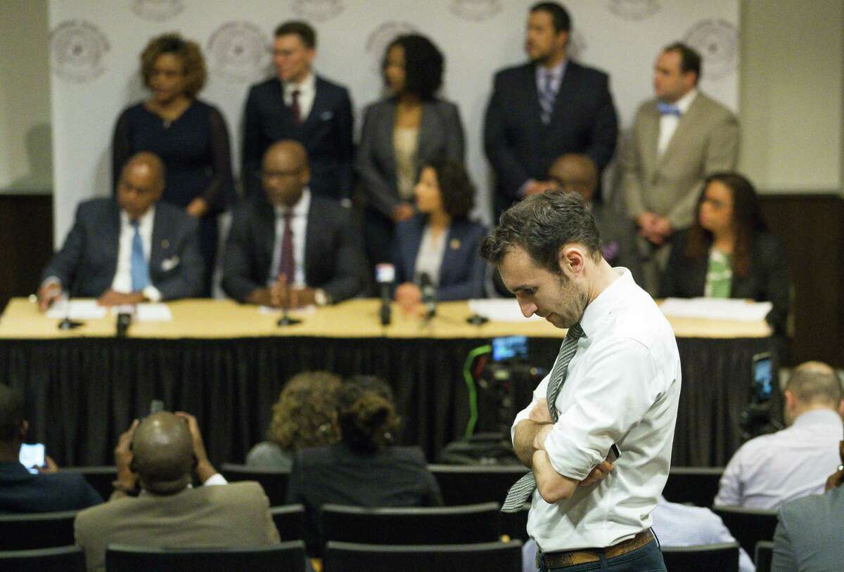 Alec Karakatsanis, who led a class action lawsuit against the county on behalf of indigent defendants challenging the county's cash bond system, listens to a press conference regarding new bail reforms for the county at Texas Southern University in Houston, Thursday, Jan. 17, 2019. The new rule allows qualifying misdemeanor arrestees to be released on a personal bond rather than a cash bond.