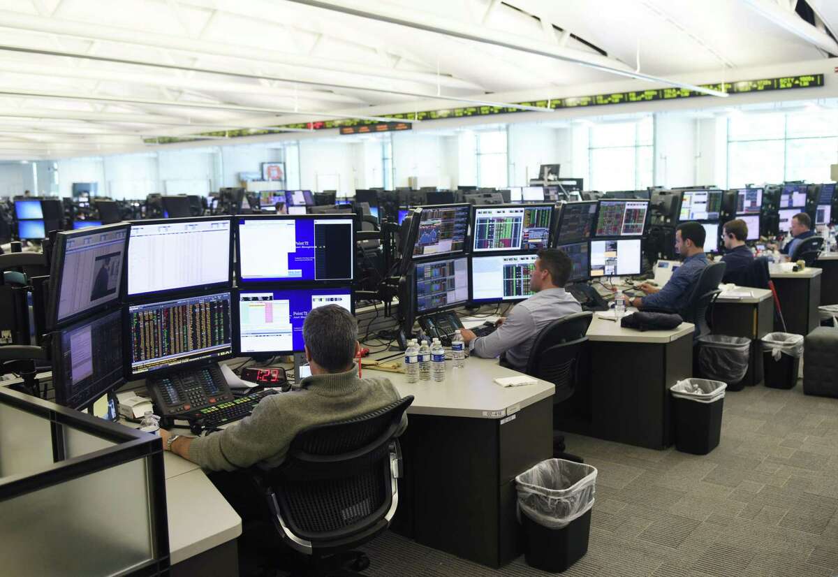 Investment professionals work on the trading floor at Point72 Asset Management's headquarters at 72 Cummings Point Road in Stamford, Conn., on July 18, 2016.