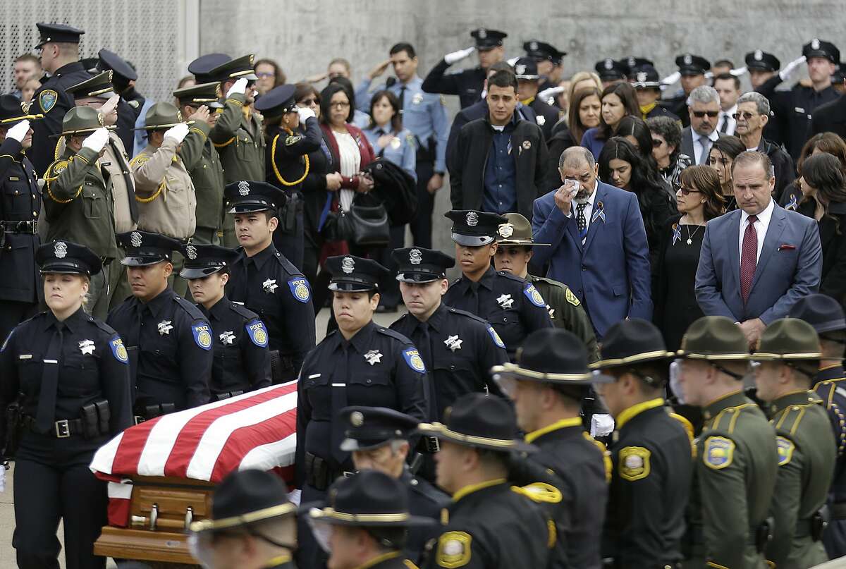 Family members follow the flag draped coffin of Davis Police Officer Natalie Corona before funeral services for Corona at the University of California, Davis, Friday, Jan. 18, 2019, in Davis, Calif. Corona was was shot and killed Jan. 10, responding to scene of a three-car crash in Davis. Police say gunman Kevin Douglas Limbaugh, 48, not involved in the crash, rode up on a bicycle and without warning, opened fire on Corona. (AP Photo/Rich Pedroncelli)