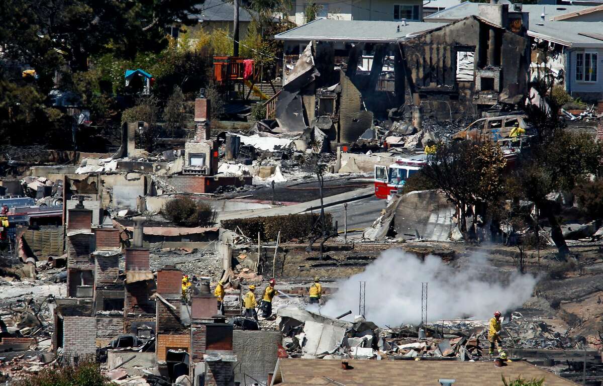 Firefighters spray water on hot spots at a home in San Bruno, Calif. on Friday, Sept. 10, 2010 thaat as destroyed after a massive natural gas pipeline explosion Thursday night.