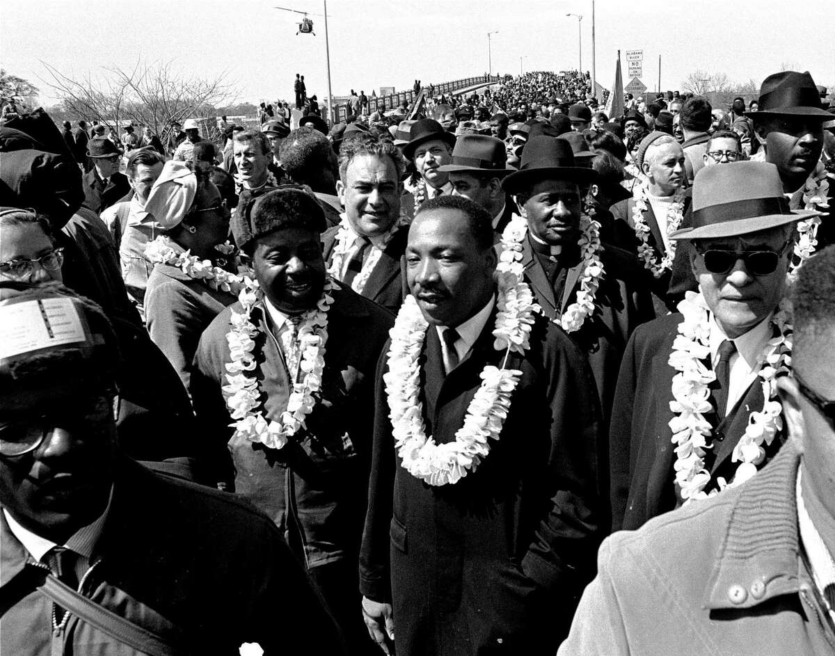 This March 21, 1965, photo shows the Rev. Martin Luther King Jr. and his civil rights marchers crossing the Edmund Pettus Bridge in Selma, Ala.