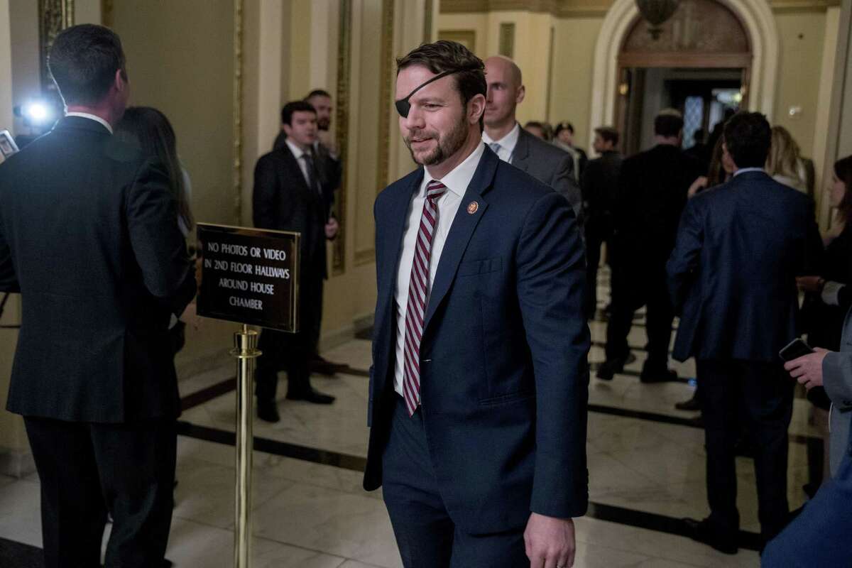 Rep. Dan Crenshaw, R-Texas, walks through the halls on Capitol Hill in Washington, Wednesday, Jan. 16, 2019. (AP Photo/Andrew Harnik)