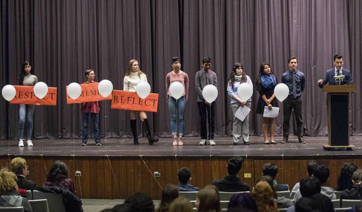 Seth Christofor, a senior at the Academy of Information Technology & Engineering, speaks to the audience during a walkout to honor the victims of the Parkland school shooting in the Rippowam Middle School auditorium. The poor lighting and sound systems in the venue have been criticized by users, leading to renters who use the venue to have to borrow their own systems. A project to improve the system has been in limbo for years, causing Board of Education members to ask when things will be fixed.