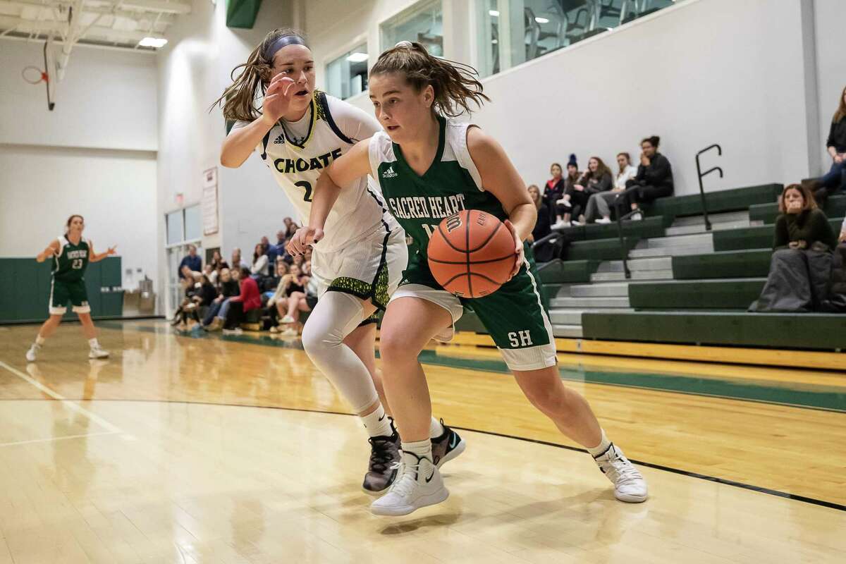 Sacred Heart’s Sophia Curto dribbles past Choate’s Chloe Blanc during their game on Friday at Sacred Heart Academy in Greenwich. Choate won 49-43.