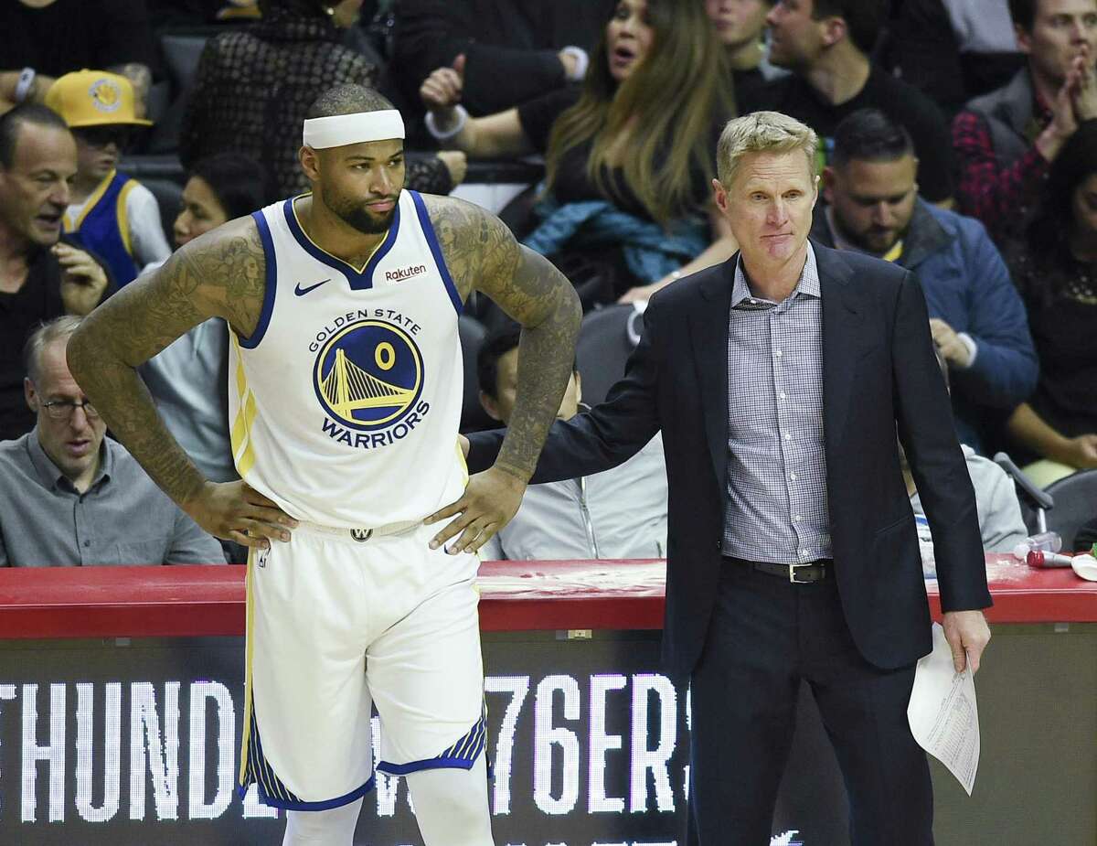 Golden State Warriors center DeMarcus Cousins, left, prepares to take the court next to head coach Steve Kerr to start the second quarter against the Los Angeles Clippers on Friday, Jan. 18, 2019 in Los Angeles, Calif.