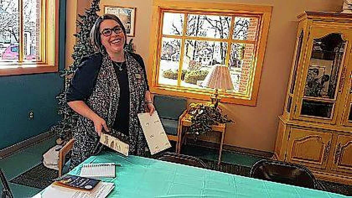 Graves-Hume Public Library director Emily Kofoid sets up for the Second Tuesday Book Club she started in Mendota. The program is one of several offerings introduced for families and adults.