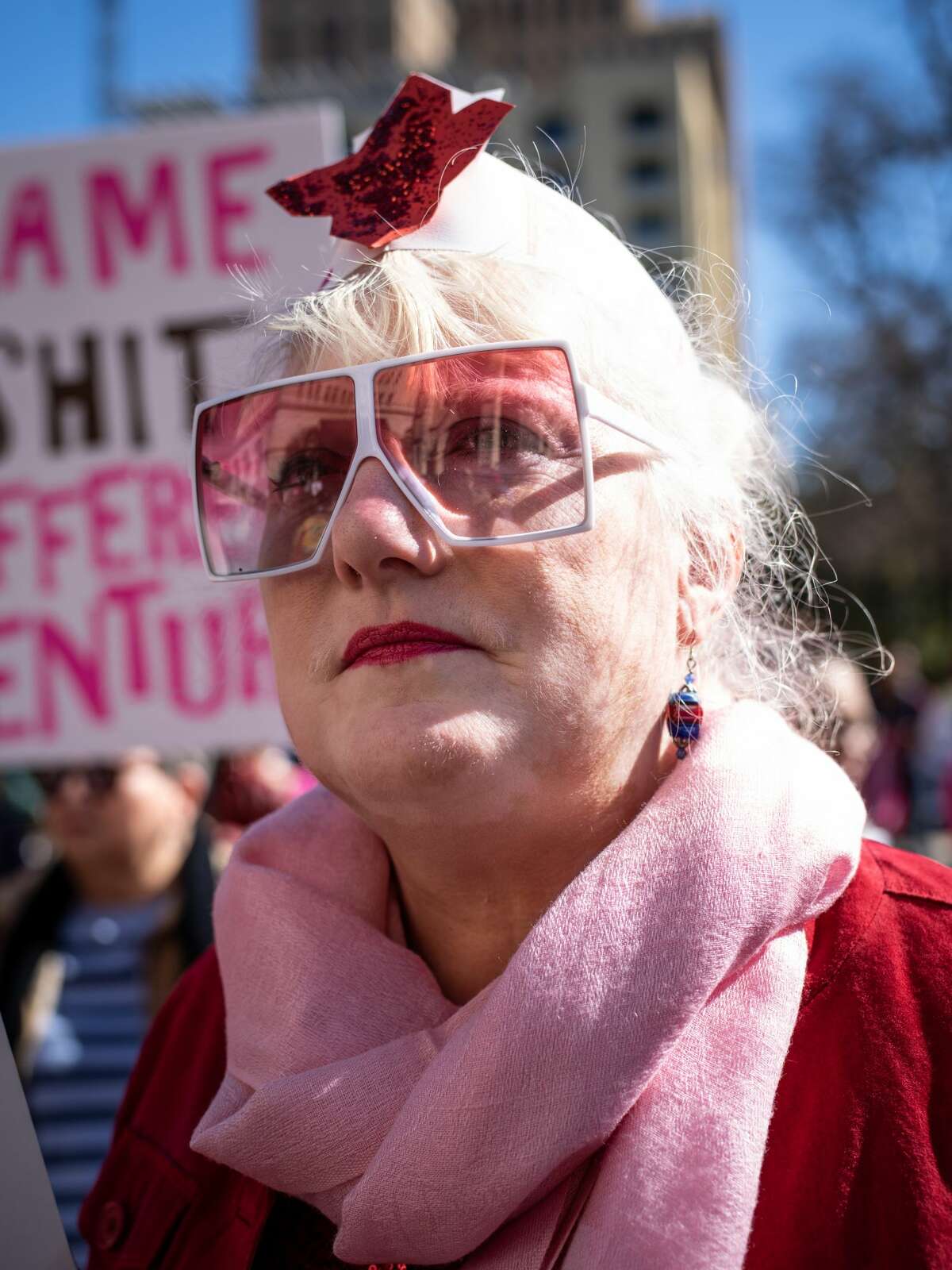 Patti Hinkley, a 20 year veteran of the U.S. Air Force, listens to speeches given during the Women's March rally on Saturday, January 19, 2019 held in front of the San Fernando Cathedral in downtown San Antonio, Texas. Hinkley said that her time in the military was plagued with harassment and discrimination based on her gender. "It was a constant fight," Patti said, "having your opinions shouted down, just having the work that you did recognized and was valid." "I try to imagine that women who go into the military now have it easier, but I'm sure it's just more subtle. I know they're still fighting just to do their job."