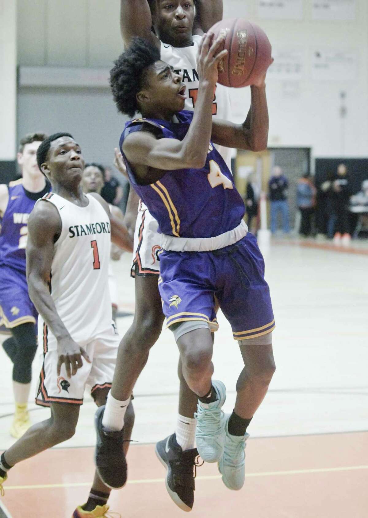 Westhill High School's JeySon Slade tries to get a shot off in a game against Stamford High School, played at Stamford High School. Saturday, Jan. 19, 2019