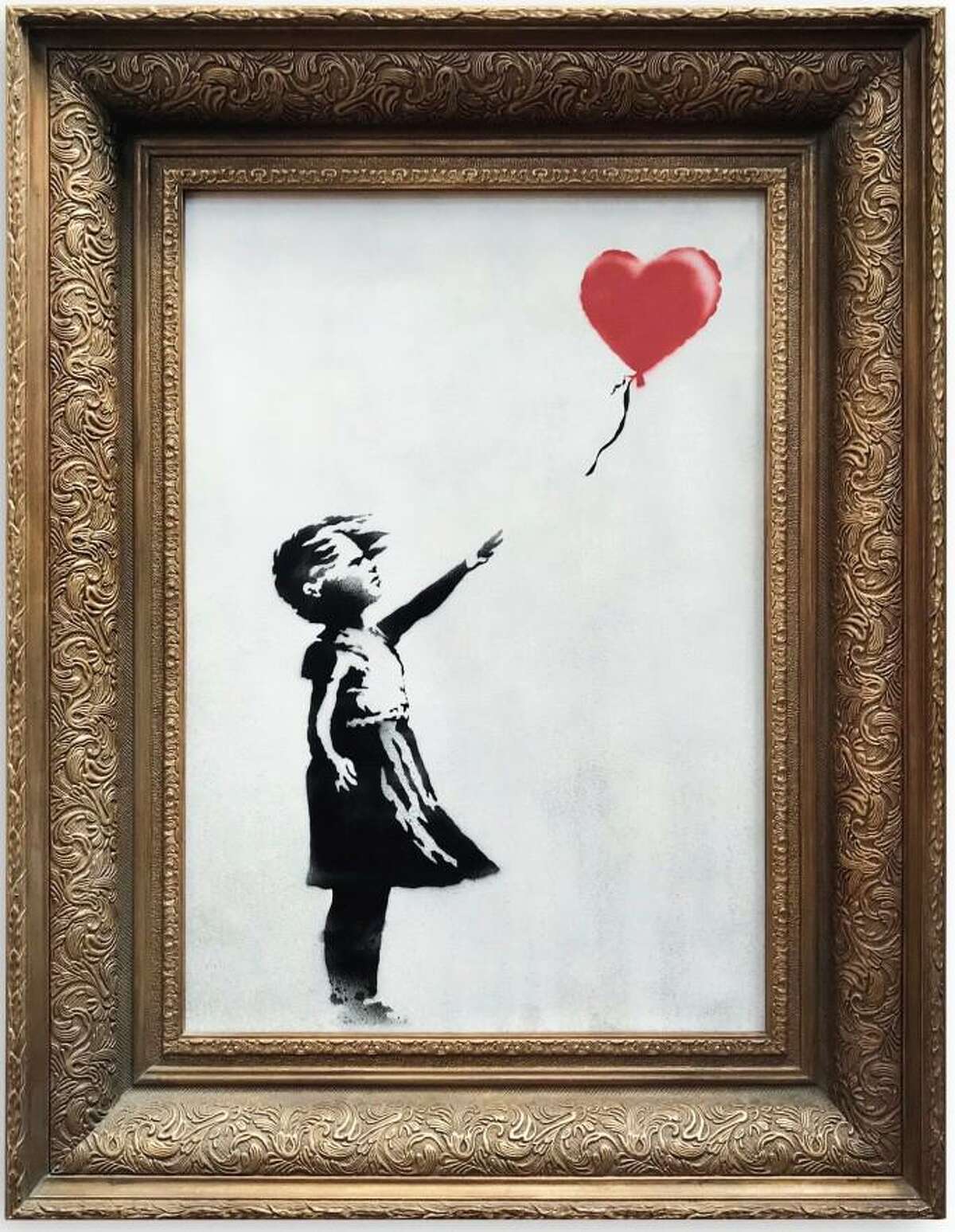 A Connecticut artist recreated this well-known Banksy painting at Women's March in New York City on Jan. 19, 2019.