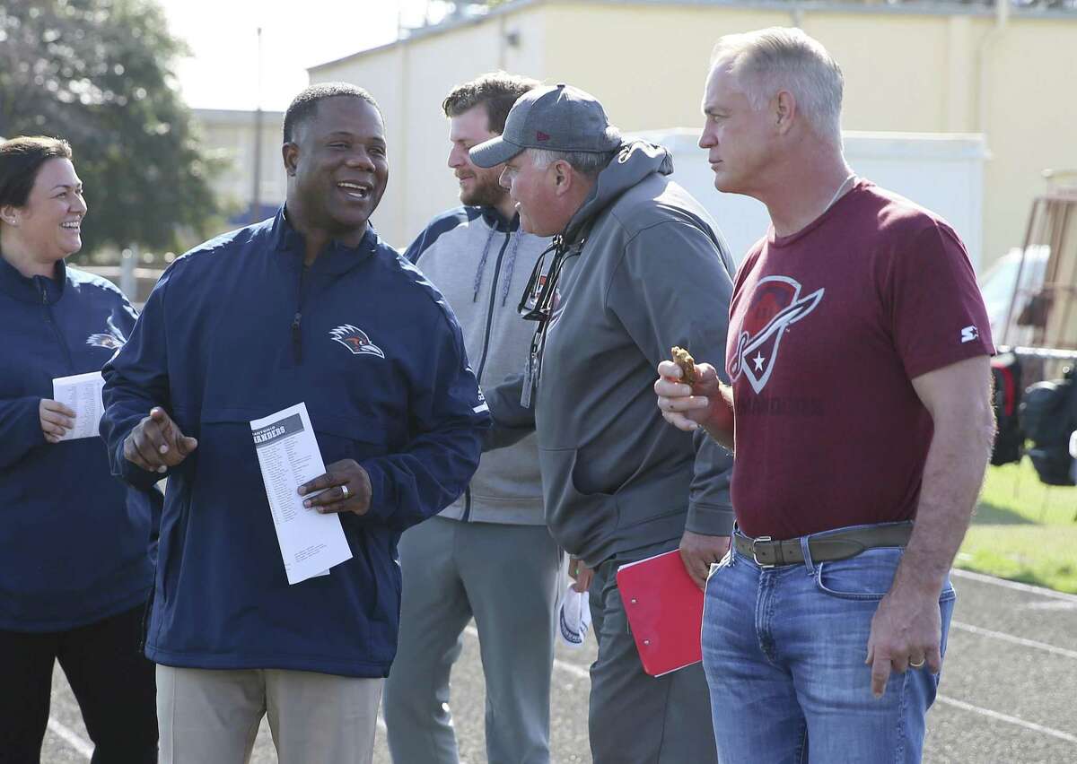 UTSA head football coach Frank Wilson (front left) joins San Antonio Commanders general manager Daryl Johnston (right) at a Commanders practice last week. The team kicks off its debut season on February 9 at the Alamodome.