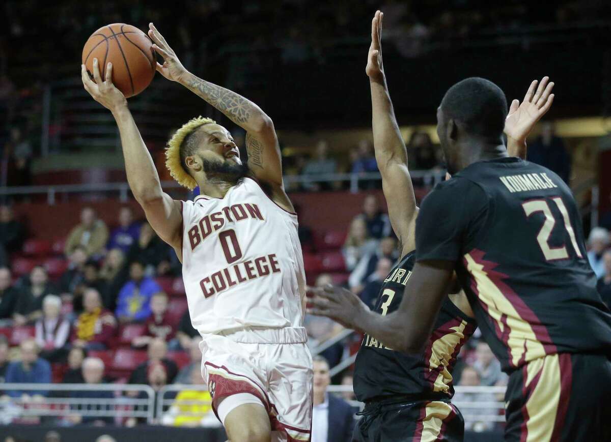 Boston College's Ky Bowman looks for an opening past Florida State's Christ Koumadje (21) in the second half of an NCAA college basketball game, Sunday, Jan. 20, 2019, in Boston. (AP Photo/Steven Senne)