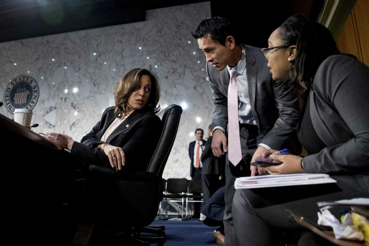 Sen. Kamala Harris, D-Calif. (left), speaks with aides during a break from testimony from Attorney General nominee William Barr at a Senate Judiciary Committee hearing on Capitol Hill in Washington Jan. 15.
