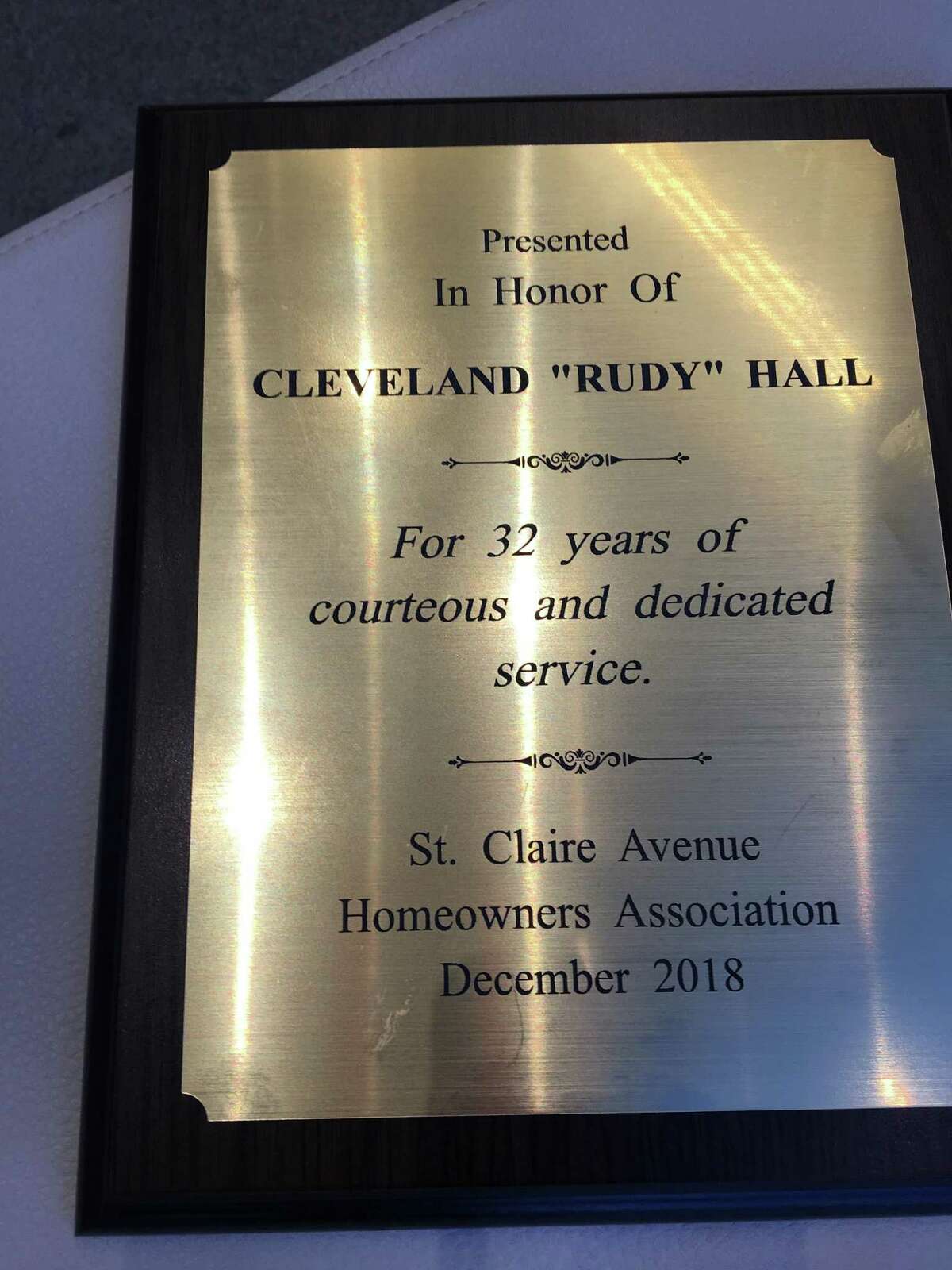 Cleveland Rudy Hall is presented with a plaque commemorating his decades of service at the St. Claire Homeowners Association late last year. He receives the award from Andy Reid the group's president, accompanied by Al Amato, after he was hospitalized for complications from diabetes. Hall died on Jan. 10.