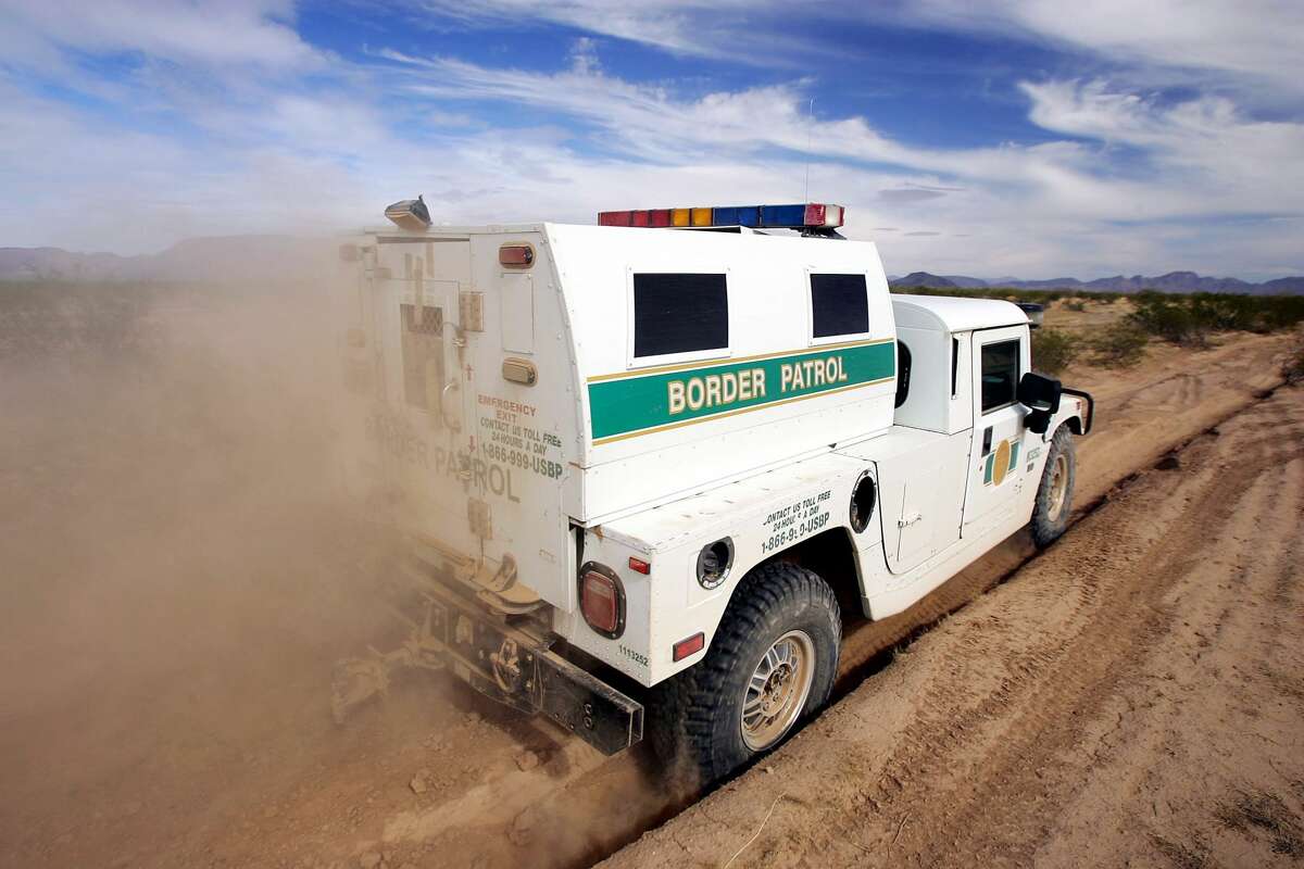 A border patrol vehicle travels a wilderness road in this file photo.