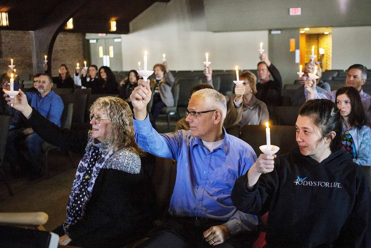 Attendees hold up their candles during the Right to Life of Midland County annual candlelight prayer vigil held at New Life Vineyard Church on Sunday, Jan. 20, 2019. The vigil was held to commemorate the the 46th anniversary of Roe vs. Wade and those impacted by abortion. (Josie Norris/for the Daily News)