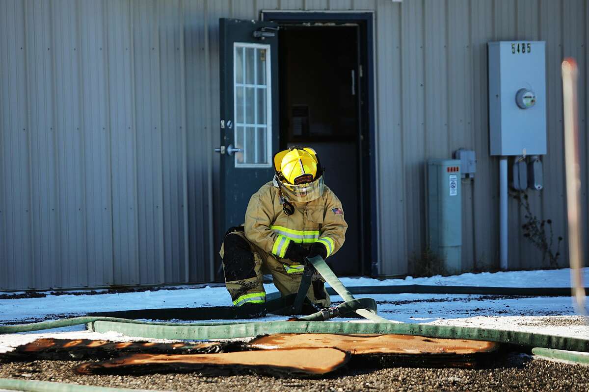 Firefighters with the Butman Township Fire Department secure the scene after putting out a fire with the assistance of other area fire departments on Monday, Jan. 21, 2019 at Nor-Pro Lawn & Landscape, Inc. in Gladwin. (Katy Kildee/kkildee@mdn.net)