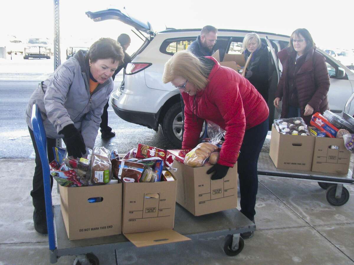 Members of Women of Michigan Action Network (WOMAN) and Arc of Midland visit the MSB International Airport on Monday, Jan. 21, 2019 to donate food and other supplies to employees of the Transportation Security Administration, one of the many organizations effected by the government shutdown. (Mitchell Kukulka/mitchell.kukulka@mdn.net)