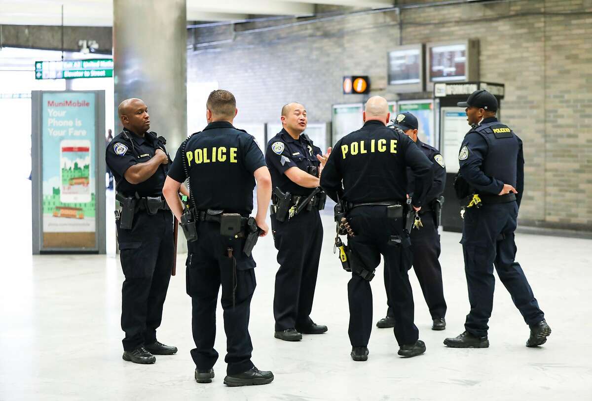 Police chat at they monitor the BART station at Civic Center in San Francisco, California, on Thursday, Aug. 16, 2018.