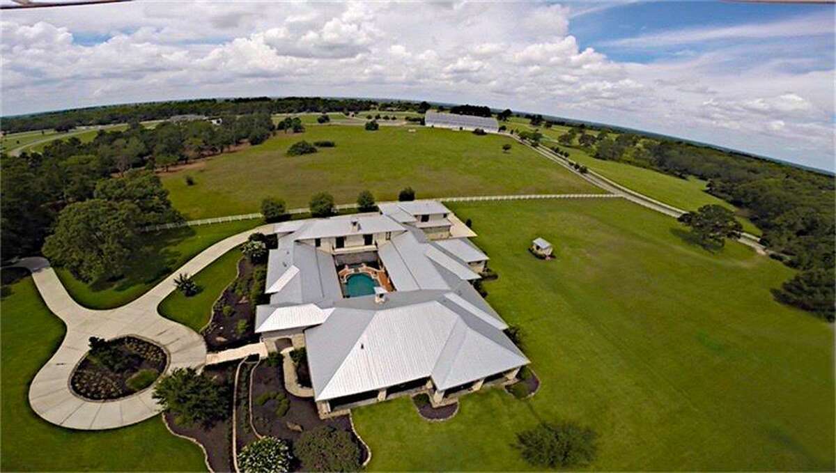 Located at 24004 Lakeview Way in Montgomery, this 10,587 square-foot ranch is a one of a kind home with colorful, intriguing interior and amenities that include a home theater room and a jaw-dropping veranda and pool that overlooks a pasture.