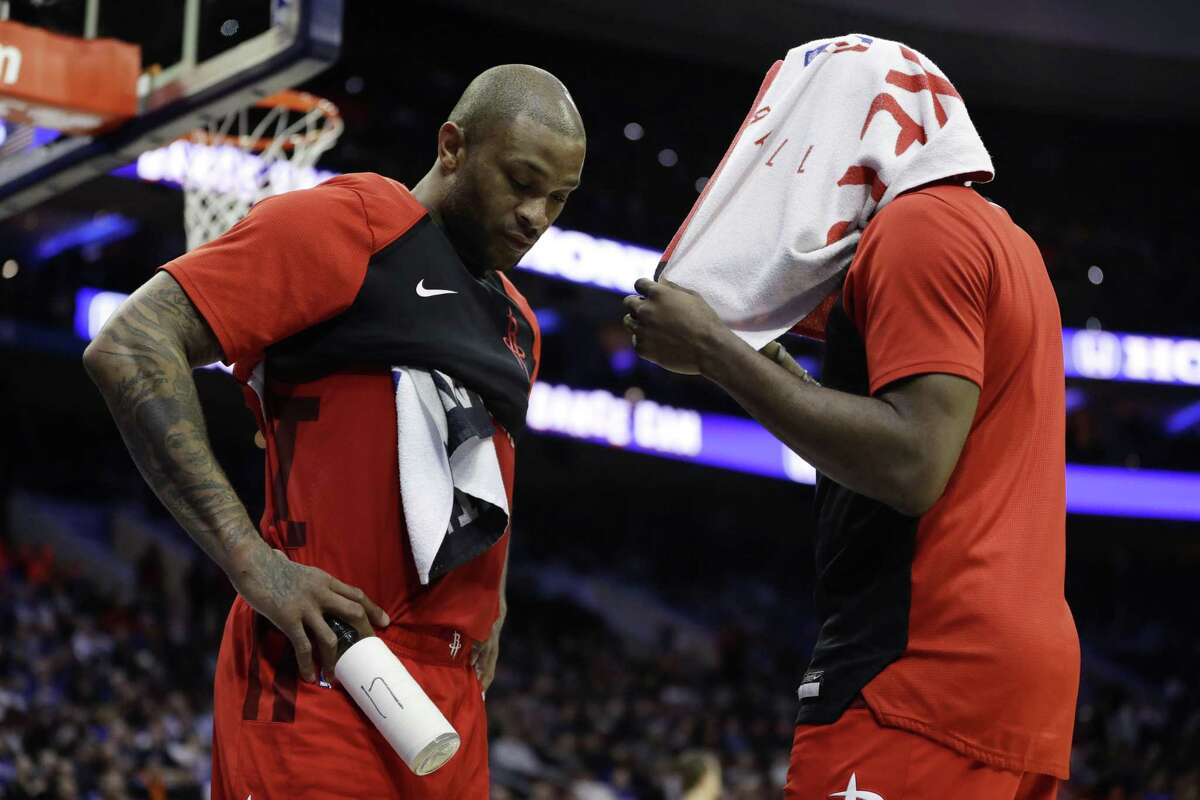The Rockets’ James Harden, right, and P.J. Tucker discuss the worsening situation during a second-half timeout Monday.