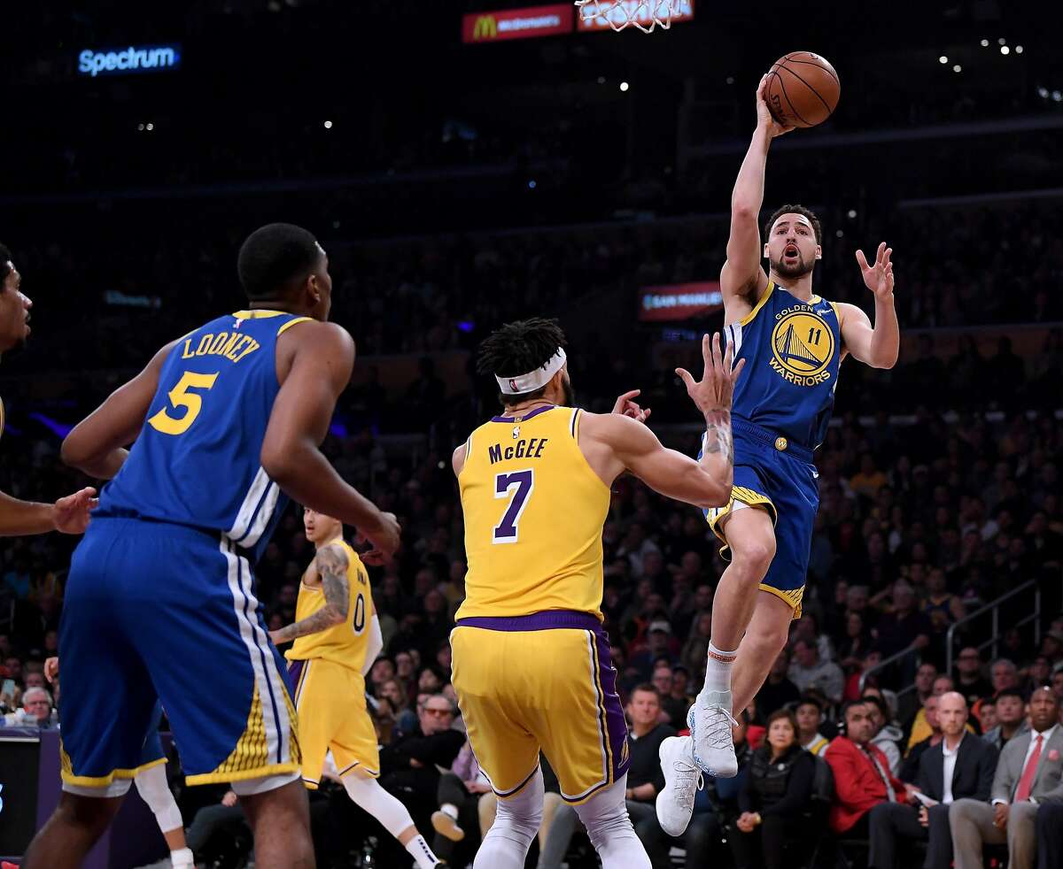 LOS ANGELES, CALIFORNIA - JANUARY 21: Klay Thompson #11 of the Golden State Warriors scores on a layup in front of JaVale McGee #7 of the Los Angeles Lakers during the first half at Staples Center on January 21, 2019 in Los Angeles, California. NOTE TO USER: User expressly acknowledges and agrees that, by downloading and or using this photograph, User is consenting to the terms and conditions of the Getty Images License Agreement. (Photo by Harry How/Getty Images)