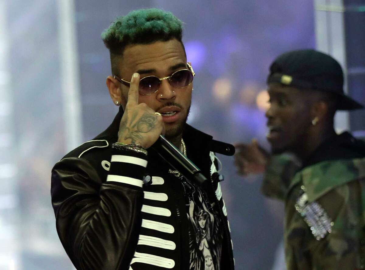 FILE - In this Sept.21, 2018 file photo, singer Chris Brown performs during Philipp Plein's women's 2019 Spring-Summer collection, unveiled during the Fashion Week in Milan, Italy. Two police officials say U.S. singer Chris Brown and two other people are in custody in Paris after a woman filed a rape complaint.