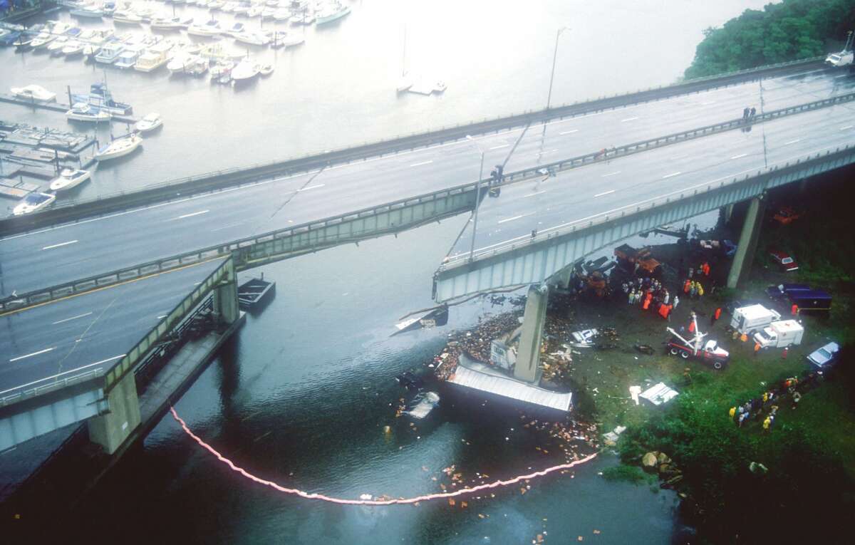 Debris lies below the Mianus River bridge June 28, 1983 in Greenwich, Connecticut, after an100-foot section of the northbound bridge gave way, sending vehicles 70 feet into the river below and killing three people.