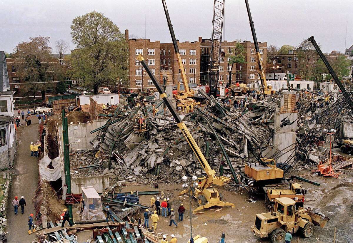 The search for dead and missing continued Saturday, April 25, 1987 at the site of a building collapse in Bridgeport, Conn. An apartment building under construction collapsed Thursday killing at least 12 and leaving 16 missing.The cranes are yellow, the up beams at left are green.